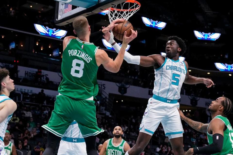 Charlotte Hornets center Mark Williams (5) try for the block on a shot by Boston Celtics center Kristaps Porzingis (8) during the second quarter at Spectrum Center.