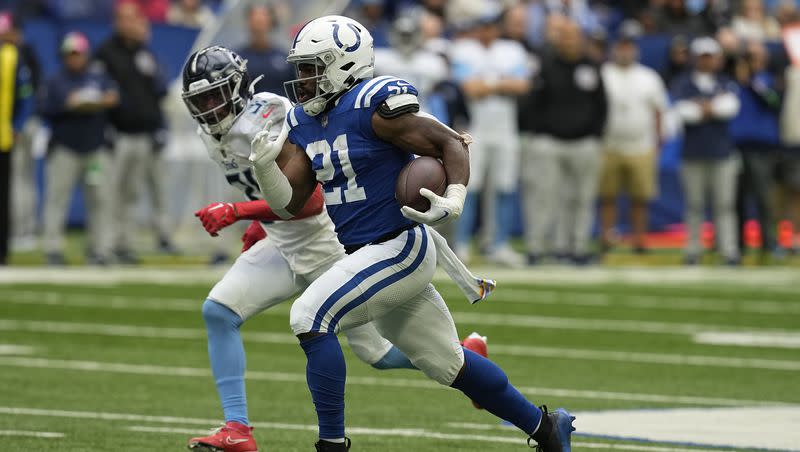 Indianapolis Colts running back Zack Moss, right, runs for a 56-yard touchdown past Tennessee Titans safety Kevin Byard (31) during the first half of an NFL football game, Sunday, Oct. 8, 2023, in Indianapolis.