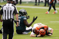 Cincinnati Bengals' Joe Burrow (9) reacts after a hit by Philadelphia Eagles' Malik Jackson (97) during the first half of an NFL football game, Sunday, Sept. 27, 2020, in Philadelphia. (AP Photo/Chris Szagola)