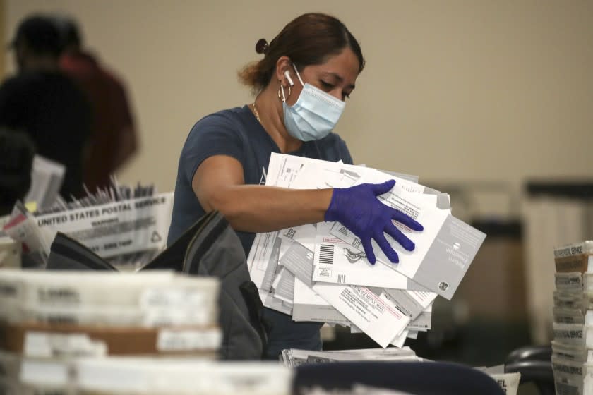 Pomona , CA - September 15: Election worker Yolanda Lavayen unbag ballots for the Sept. 14, recall election at the Los Angeles County Registrar of Voters satellite office at Fairplex on Wednesday, Sept. 15, 2021 in Pomona , CA. (Irfan Khan / Los Angeles Times)