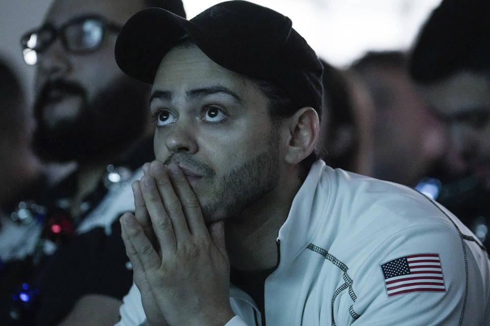 Assembly integration and test Engineer for Intuitive Machines, Mario Romero joins fellow Intuitive Machines employees for a watch party as they hope to be the first commercial company to softly land on the moon on Thursday, Feb. 22, 2024, in Houston. ( Raquel Natalicchio/Houston Chronicle via AP)