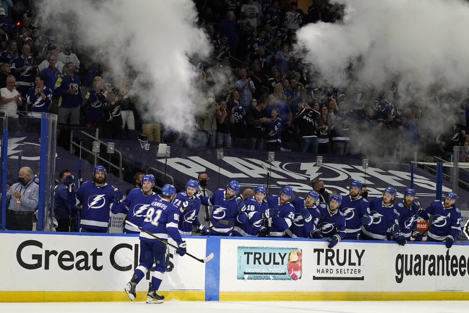 Tampa Bay Lightning center Steven Stamkos (91) celebrates with the bench after his goal against the Carolina Hurricanes during the second period in Game 4 of an NHL hockey Stanley Cup second-round playoff series Saturday, June 5, 2021, in Tampa, Fla. (AP Photo/Chris O'Meara)