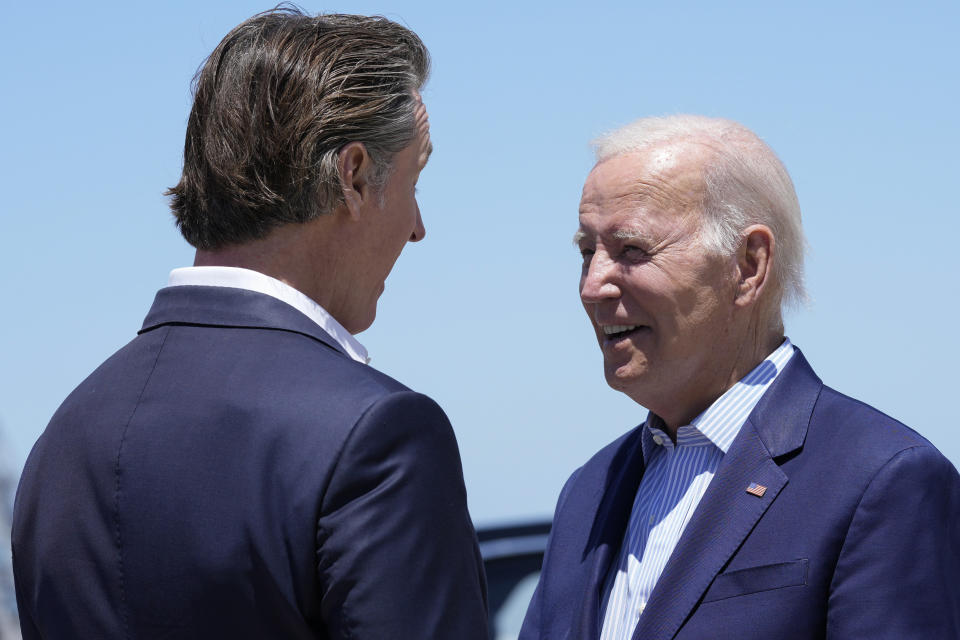 President Joe Biden talks with California Gov. Gavin Newsom as he arrives at Moffett Federal Airfield, Calif., Monday, June 19, 2023. Biden is ramping up his reelection effort this week with four fundraisers in the San Francisco area, as his campaign builds up its coffers and lays strategic foundations for 2024. (AP Photo/Susan Walsh)
