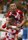 Croatia's Ivan Perisic celebrates after scoring a goal with teammate Ivica Olic (top) during their 2014 World Cup Group A soccer match against Cameroon at the Amazonia arena in Manaus June 18, 2014. REUTERS/Yves Herman (BRAZIL - Tags: SOCCER SPORT WORLD CUP)