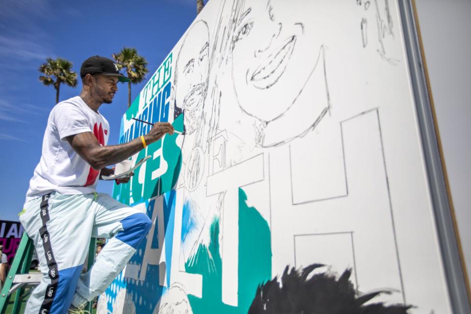 Visual artist Tony Concep paints a mural.