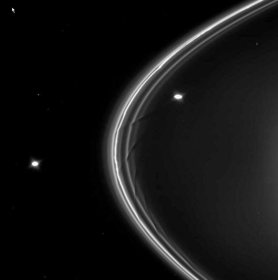 Saturn's strange F ring and its two shepherd moons, Prometheus (right) and Pandora (left), are seen by NASA's Cassini spacecraft in this image. Saturn itself is located out of frame, to the right.