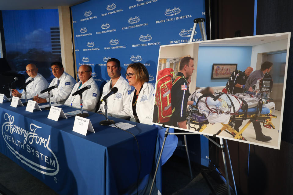 A photo of a patient being transported is displayed while medical staff at Henry Ford Hospital answer questions during a news conference in Detroit, Tuesday, Nov. 12, 2019. A Henry Ford Health System medical team performed a double lung transplant, for the unidentified patient in the photograph, whose lungs were irreparably damaged from vaping. (AP Photo/Paul Sancya)