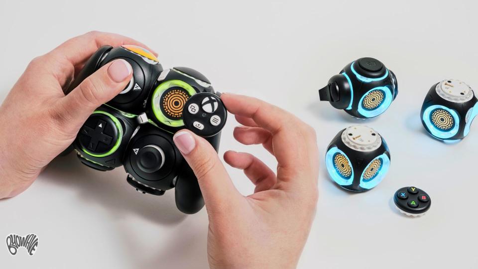 Two hands customizing the modular ByoWaveProteus Controller. It includes sphere-like nodes with various controller functions.