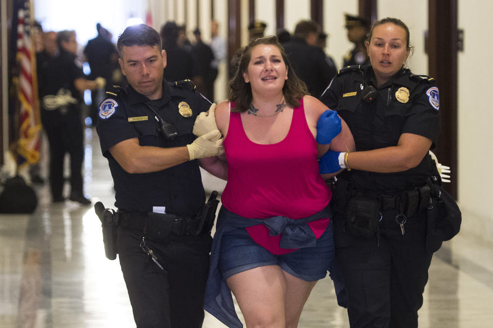 <p>U.S. Capitol Police arrest a protester demonstrating against the Senate Republican health care bill, outside the office of Sen. Patrick Toomey, Republican of Pennsylvania, on Capitol Hill in Washington, June 28, 2017. (Photo: Saul Loeb/AFP/Getty Images) </p>