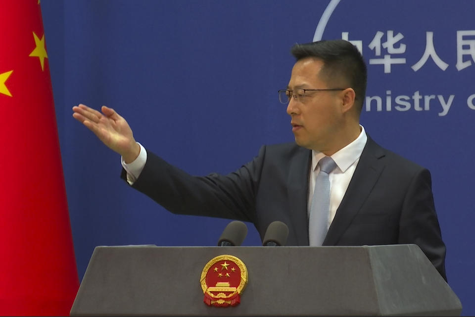 Chinese Foreign Ministry spokesperson Zhao Lijian invites questions during a press conference in Beijing, China, Tuesday, Dec. 7, 2021. China on Tuesday accused the United States of violating the Olympic spirit by announcing an American diplomatic boycott of February's Beijing Winter Games. (AP Photo/Liu Zheng)