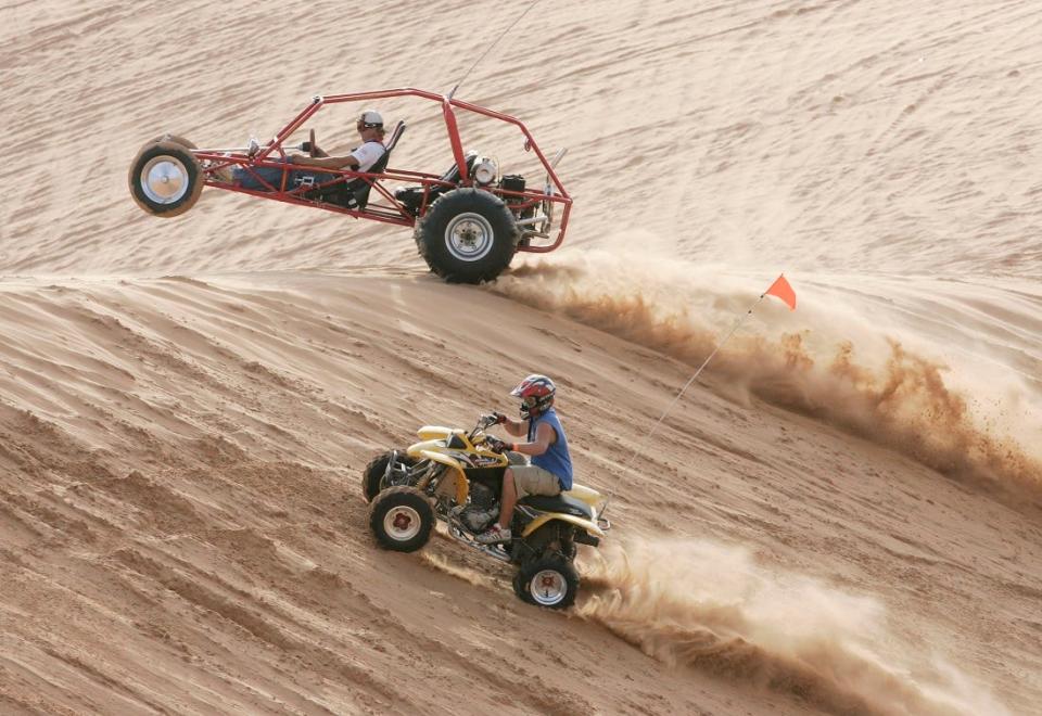 Sandsport enthusiasts race up a sand dune as they participate during at Little Sahara State Park, near Waynoka, Okla. [The Oklahoman Archives]