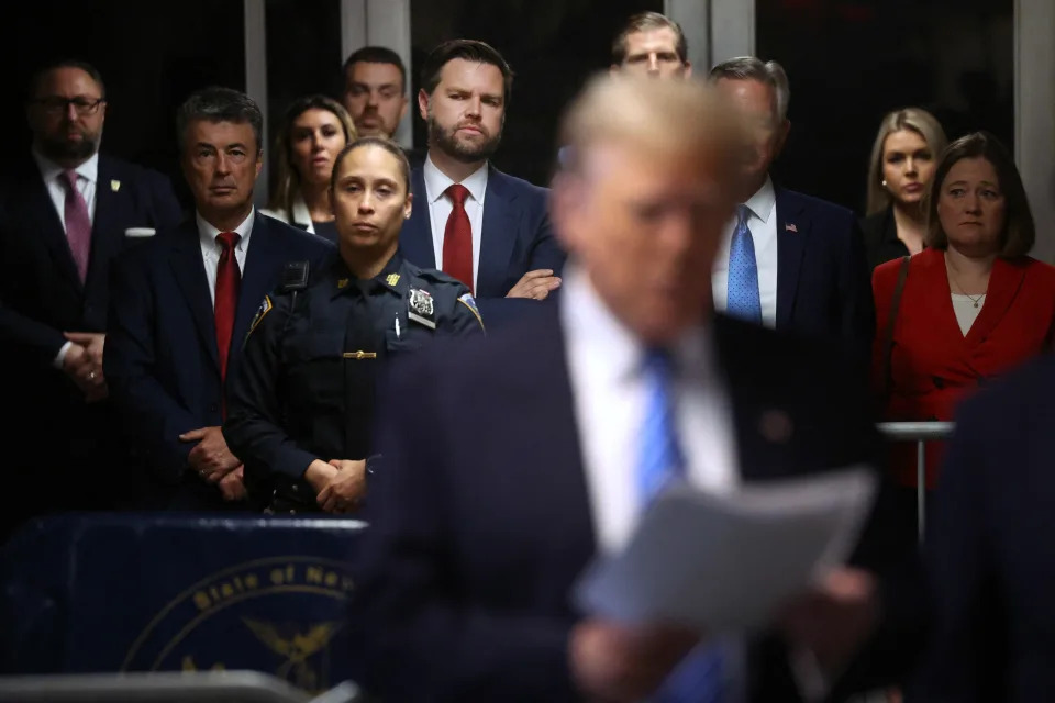 Senator J.D. Vance (center,red tie)(R-OH) looks on as former US President Donald Trump speaks to the media at his trial for allegedly covering up hush money payments at Manhattan Criminal Court, in New York City, on May 13, 2024. Donald Trump's criminal trial in New York was expected to hear his former lawyer turned tormentor Michael Cohen testify Monday about his role in what prosecutors say was a cover up of payments to hide an affair. (Photo by Spencer Platt / POOL / AFP) (Photo by SPENCER PLATT/POOL/AFP via Getty Images)