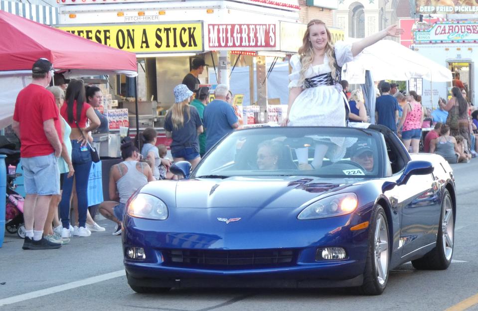 Hannah Feldman, who later would be named this year's queen, waves to the crowd during Thursday's parade at the 2022 Bucyrus Bratwurst Festival.