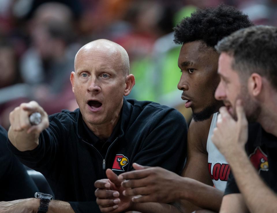 Louisville coach Chris Mack discusses a play with Jae'lyn Withers during an exhibition game against Kentucky State, at the YUM Center. Oct. 29, 2021