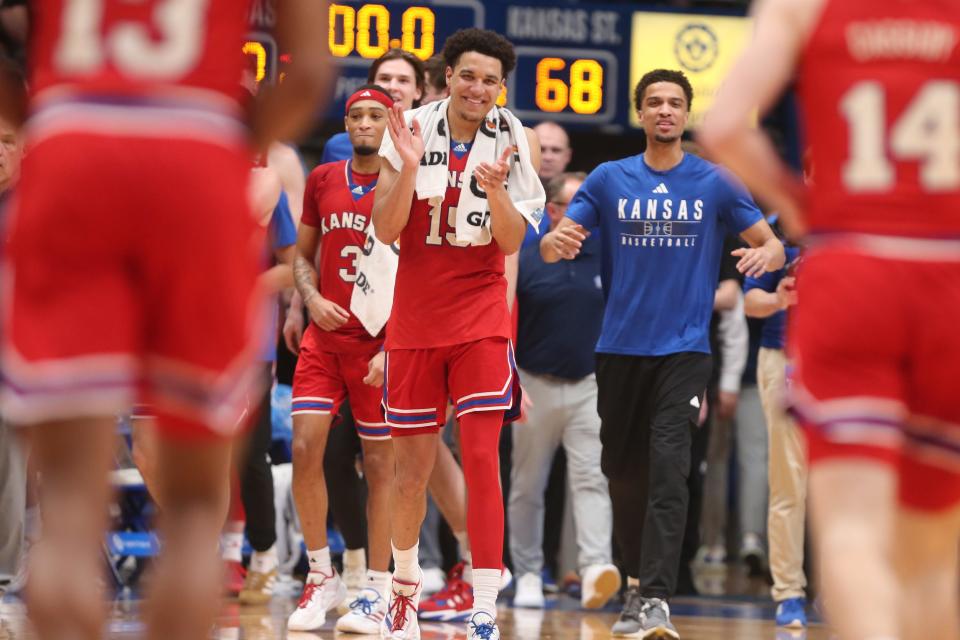Kansas graduate senior guard Kevin McCullar Jr. (15) welcomes back teammates after defeating Kansas State 90-68 in the Sunflower Showdown inside Allen Fieldhouse on March 5, 2024.