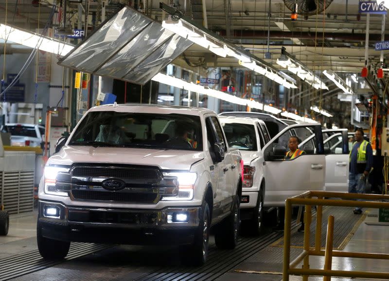 FILE PHOTO: Newly assembled Ford F150 pick-up trucks are driven off the assembly line during the 100-year celebration of the Ford River Rouge Complex in Dearborn