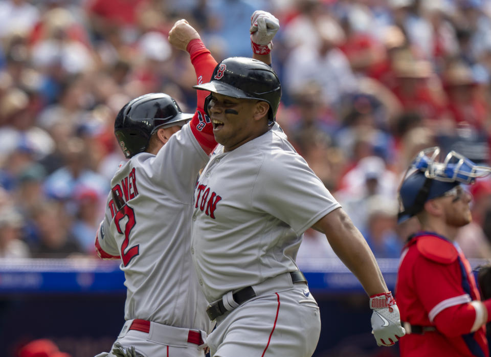 Boston Red Sox Rafael Devers, right celebrates his two run home run with teammate Justin Turner (2) during the third inning of a baseball game against the Toronto Blue Jays in Toronto on Saturday, July 1, 2023. (Frank Gunn/The Canadian Press via AP)