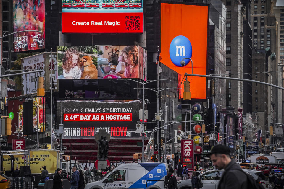 A Times Square billboard displays a poster of Hamas hostage Emily Hand, Friday, Nov. 17, 2023, in New York. Hand is believed to be somewhere in Gaza among the hostages taken by Hamas militants, after they swarmed her Kibbutz on Oct. 7 during an incursion into Israel. Today is Hand's ninth birthday. (AP Photo/Bebeto Matthews)