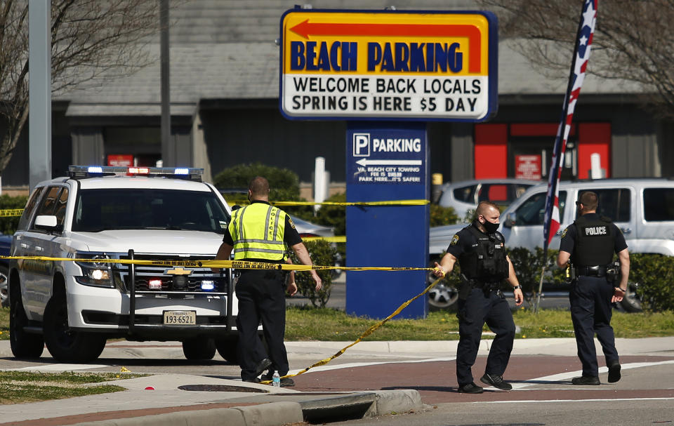 Virginia Beach police put up police tape across Pacific Ave. at the Oceanfront on Saturday, March 27, 2021, morning after a fatal shooting the night before in Virginia Beach, Va. A pair of overnight fatal shootings along the beachfront in Virginia Beach wounded several people in a scene described by authorities on Saturday as “very chaotic.” (Stephen Katz /The Virginian-Pilot via AP)
