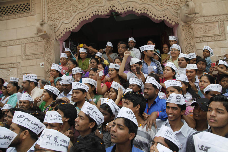 Supporters listen to Aam Aadmi Party (AAP), or common man party, chief Arvind Kejriwal during an election campaign rally in New Delhi, India, Wednesday, April, 2, 2014. The election commission says 363 political parties participated in the 2009 elections. The number will likely be similar in this election that will be held from April 7 to May 12, although only seven of these are nationally recognized parties and another 34 were recognized as regional parties. (AP Photo/Tsering Topgyal)