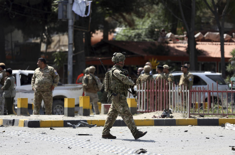 Resolute Support (RS) forces and Afghan security personnel inspect the site of a car bomb explosion in Kabul, Afghanistan, Thursday, Sept. 5, 2019. A car bomb rocked the Afghan capital on Thursday and smoke rose from a part of eastern Kabul near a neighborhood housing the U.S. Embassy, the NATO Resolute Support mission and other diplomatic missions. (AP Photo/Rahmat Gul)