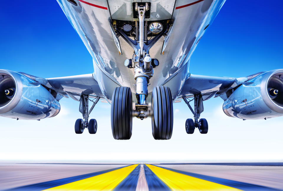 A view from underneath as a plane takes off from a runway