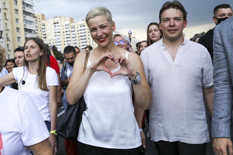 FILE - In this Aug. 30, 2020, file photo, Maria Kolesnikova, one of Belarus' opposition leaders, center, gestures, during a rally in Minsk, Belarus. Kolesnikova, a professional flute player with no political experience, emerged as a key opposition activist in Belarus. She has appeared at protests of authoritarian President Alexander Lukashenko after he was kept in power by an Aug. 9 election that his critics say was rigged. (AP Photo/File)