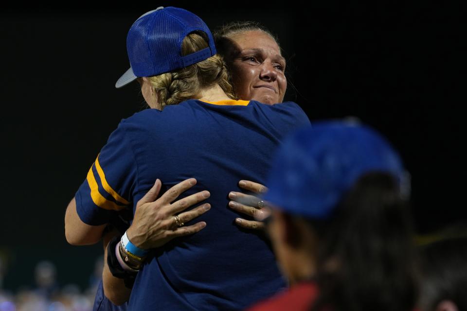 Carly Accardo, right, who runs a local girls baseball league she started for her daughter Leighton, who passed away due to cancer in 2020, tears up after telling her story and receives a hug from Baseball for All founder Justine Siegal during their opening ceremony at Hohokam Stadium in Mesa, Ariz. on Wednesday, July 20, 2022. 