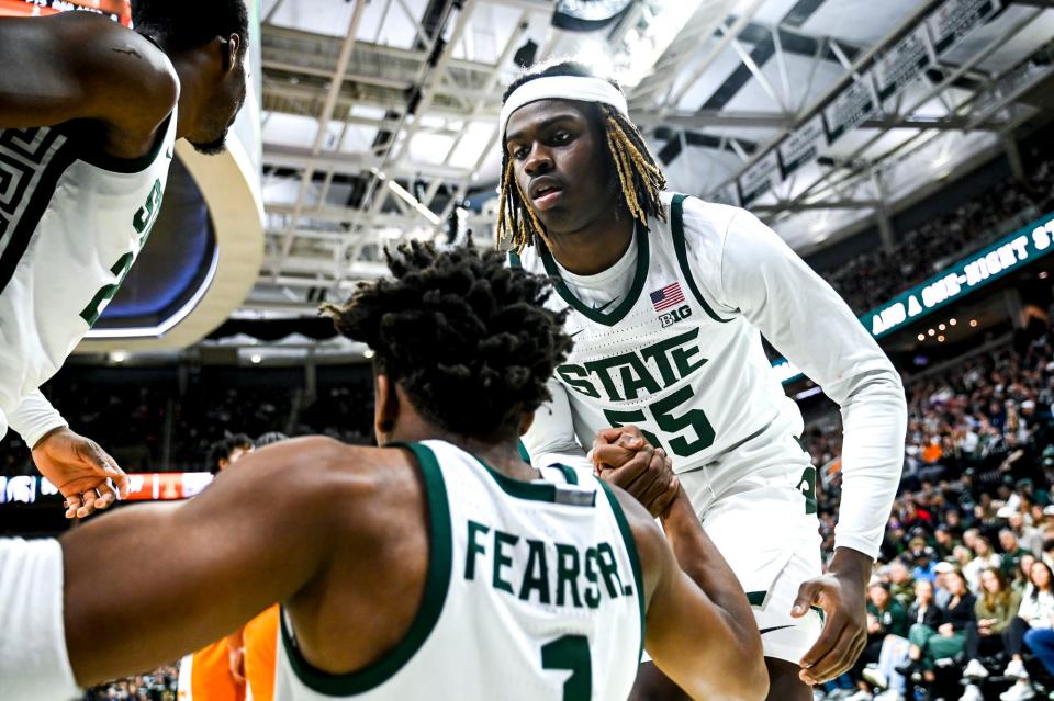 Michigan State's Mady Sissoko, left, and Coen Carr, right, help up teammate Jeremy Fears Jr. during the second half in the game against Tennessee on Sunday, Oct. 29, 2023, at the Breslin Center in East Lansing.