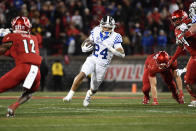 Kentucky running back Chris Rodriguez Jr. (24) runs through an opening in the Louisville line during the first half of an NCAA college football game in Louisville, Ky., Saturday, Nov. 27, 2021. (AP Photo/Timothy D. Easley)