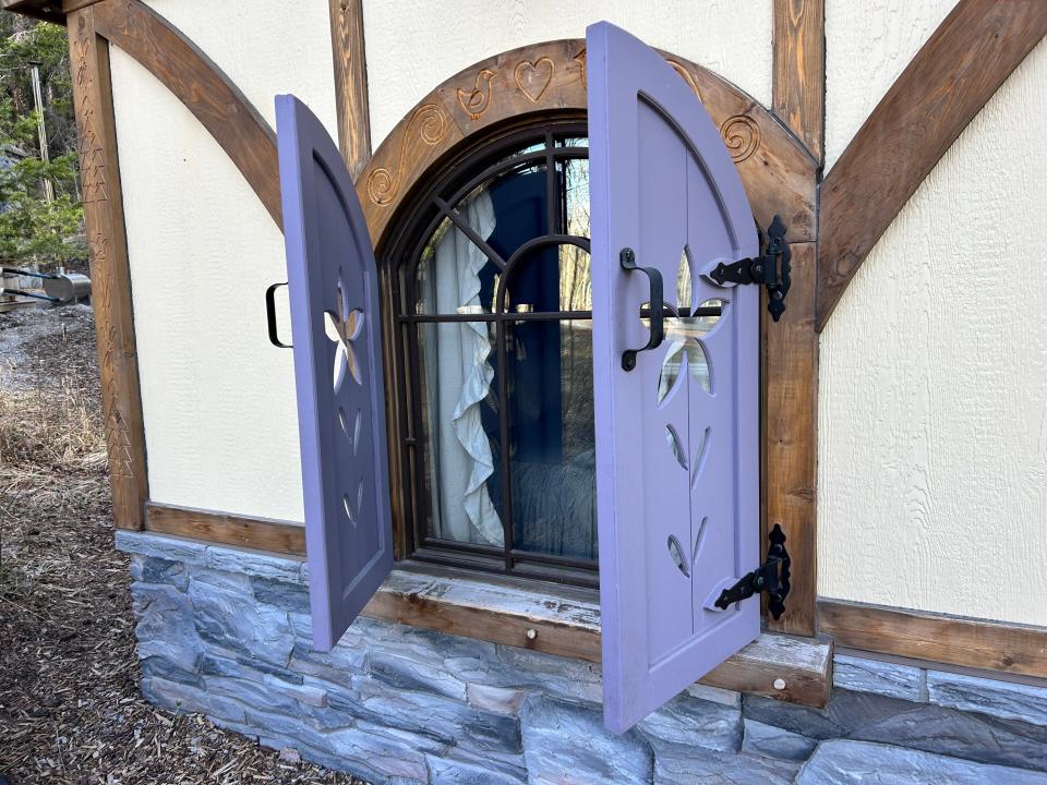 purple shutters outside rapunzel's cottage