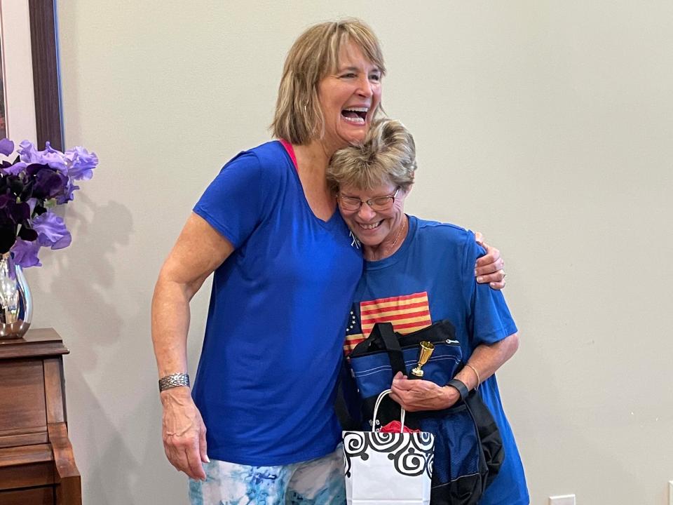 S.A.I.L. instructor Debbie Harris turns the tables on good friend Aggie Hankins by giving her a goodbye present at the retirement party held for Harris at the Karns Senior Center, Wednesday, May 4, 2022.