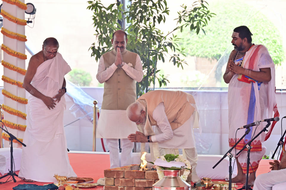 Indian prime minister Narendra Modi prays before inaugurating the new parliament building, in New Delhi, India, Sunday, May 28, 2023. The new triangular parliament building, built at an estimated cost of $120 million, is part of a $2.8 billion revamp of British-era offices and residences in central New Delhi called "Central Vista", even as India's major opposition parties boycotted the inauguration, in a rare show of unity against the Hindu nationalist ruling party that has completed nine years in power and is seeking a third term in crucial general elections next year. (AP Photo)