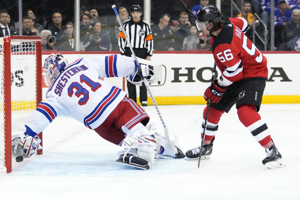 New York Rangers goaltender Igor Shesterkin (31) dives for the puck shot by New Jersey Devils' Erik Haula (56) for a goal during the second period of Game 5 of an NHL hockey Stanley Cup first-round playoff series Thursday, April 27, 2023, in Newark, N.J. (AP Photo/Frank Franklin II)