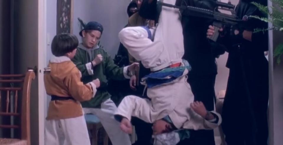 The 3 ninjas fight against bad guys dressed in black in their house