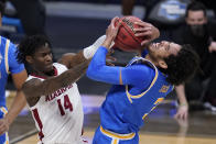 Alabama guard Keon Ellis (14) ties up UCLA guard Johnny Juzang (3) in the first half of a Sweet 16 game in the NCAA men's college basketball tournament at Hinkle Fieldhouse in Indianapolis, Sunday, March 28, 2021. (AP Photo/Michael Conroy)