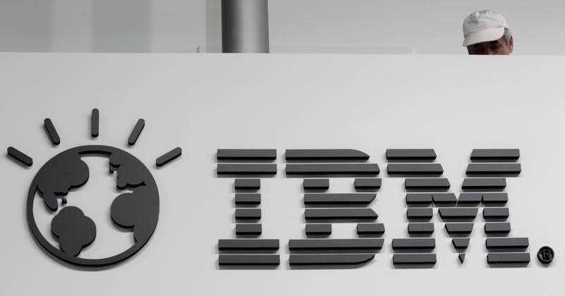 A worker is pictured behind a logo at the IBM stand on the CeBIT computer fair in Hanover February 26, 2011. REUTERS/Tobias Schwarz