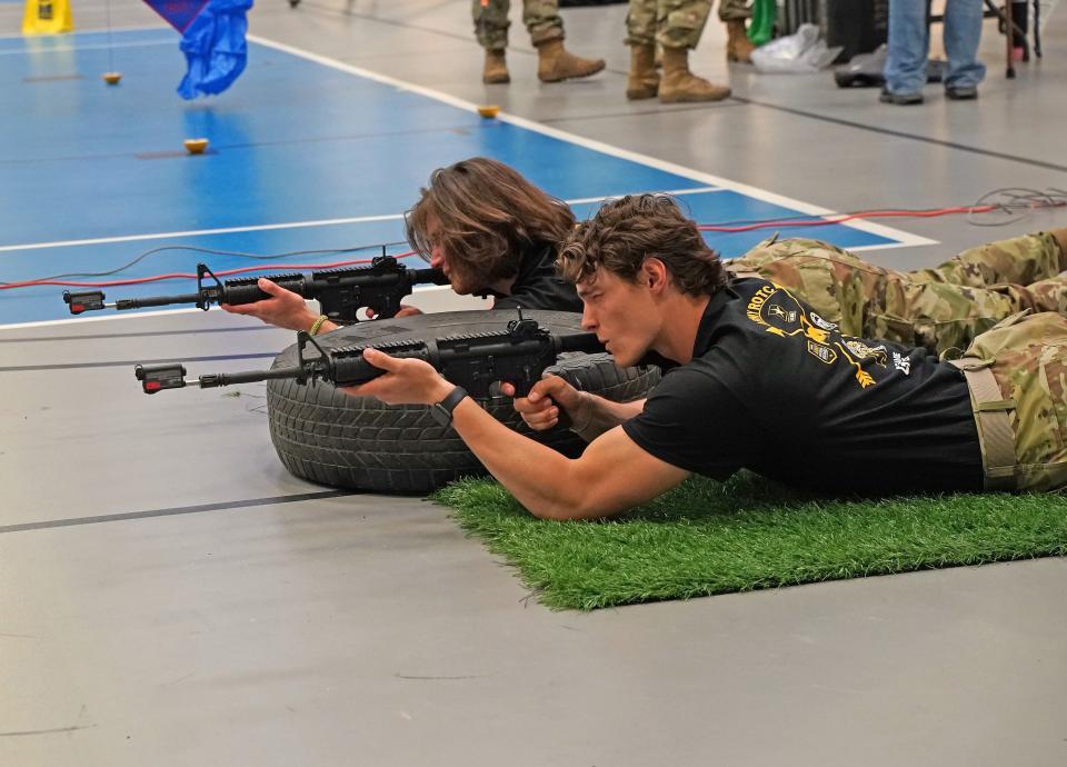 Gavin Daum, in foreground, and Aiden Thede, both freshmen at Adrian College and enrolled in the Reserve Officers’ Training Corps (ROTC), test their marksmanship on a "smokeless range" with M4 rifles during AC's "Meet the Army Community Day" Friday, April 12, 2024.