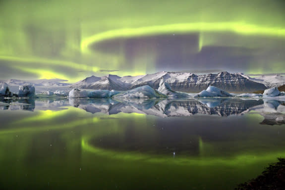 This overall winning photo shows a green aurora above a glacial lagoon in Iceland.