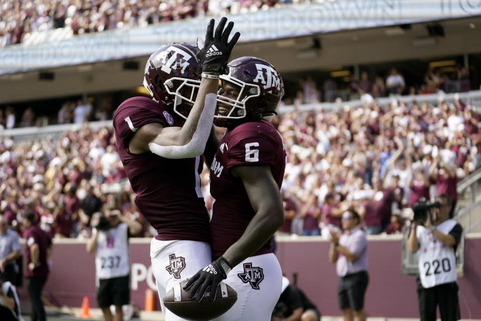 Texas A&M running back Devon Achane (6) reacts with teammate Demond Demas (1) after scoring a touchdown during the first half of an NCAA college football game against New Mexico, Saturday, Sept. 18, 2021, in College Station, Texas. (AP Photo/Sam Craft)