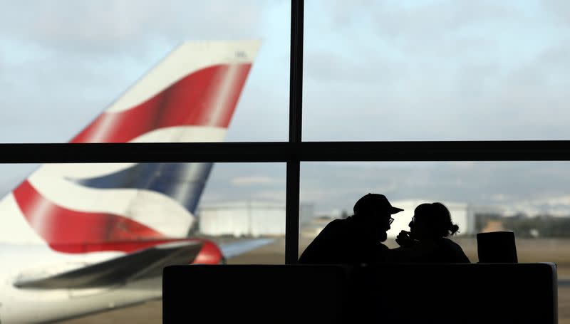 A British Airways Boeing 747 passenger aircraft prepares to take off as passengers wait to board a flight in Cape Town International airport in Cape Town