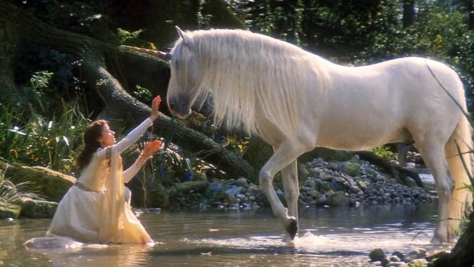 Mia Sara pets a unicorn in the 1985 film Legend.