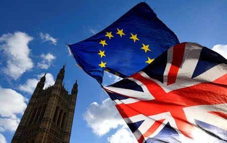 FILE PHOTO: British and EU flags flutter outside the Houses of Parliament in London, Britain January 30, 2019. REUTERS/Toby Melville/File Photo