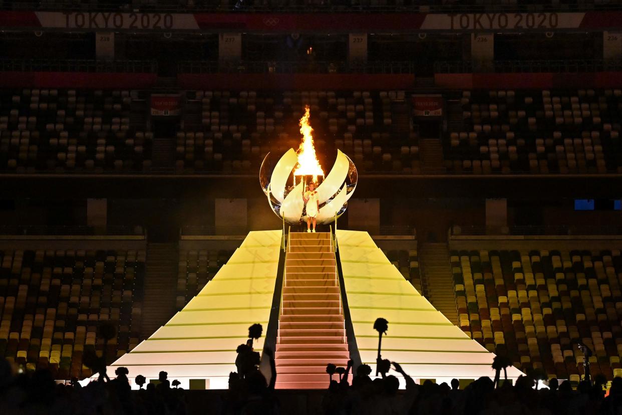 Naomi Osaka lights the Olympic flame (AFP via Getty Images)