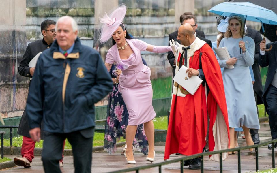 The singer loses her footing when exiting the Abbey after the Coronation ceremony - Reuters