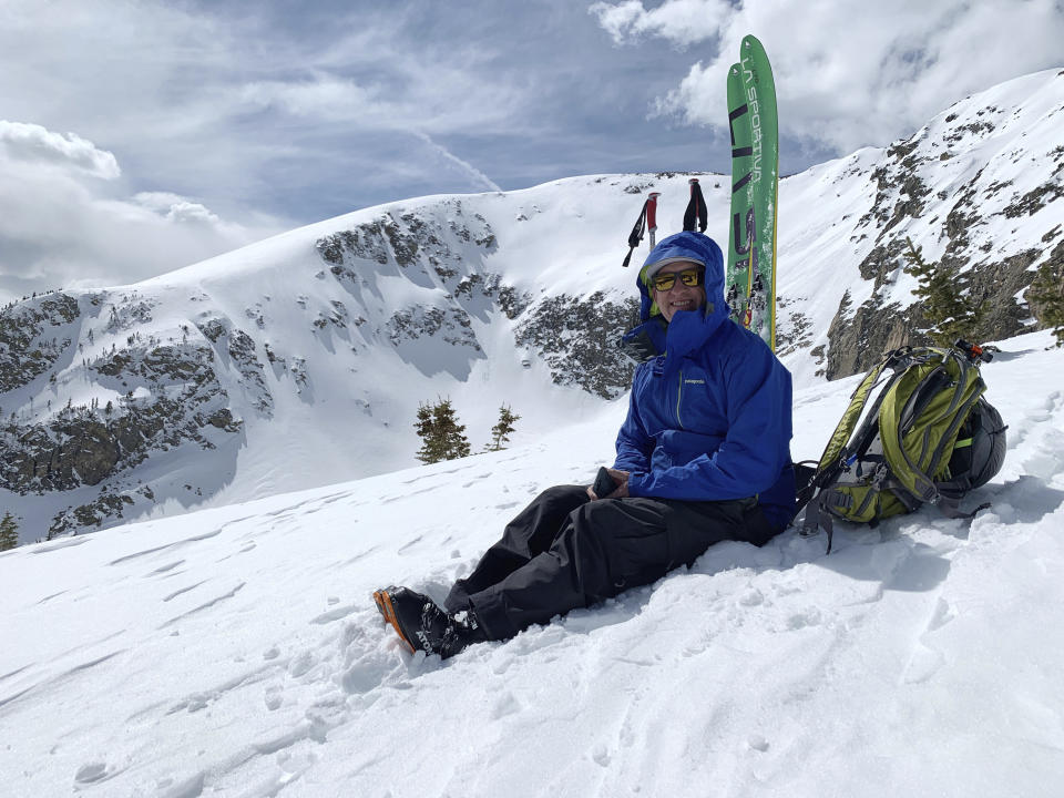 In this handout photograph taken Tuesday, March 17, 2020 and provided by Jack Hagan, Drew Anderson is shown on the top of Buffalo Mountain near Silverthorne, Colo. The outdoors has become a great escape for people as the new cronoavirus creates a wave of turbulent times. The new coronavirus causes mild or moderate symptoms for most people, but for some, especially older adults and people with existing heath problems, it can cause more severe illness or death. (Photo Courtesy of Jack Hagan via The AP)