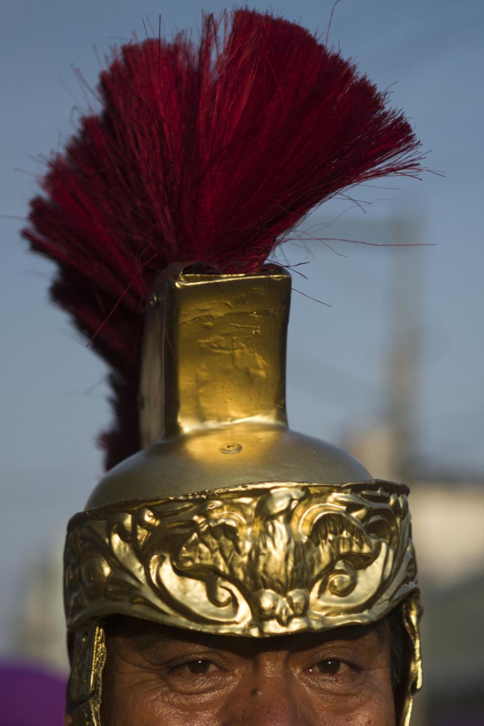 In this April 13, 2014 photo, Mario Eduardo Garcia poses for a portrait dressed as a Roman soldier during the procession by Saint Joseph church in Guatemala City. Garcia has participated as a Roman soldier in the Palm Sunday procession for the last 38 years. (AP Photo/Moises Castillo)