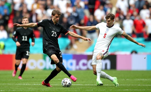 England’s John Stones and Germany's Thomas Muller