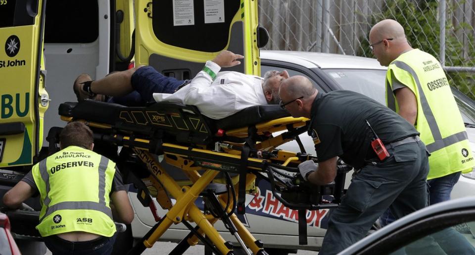 Ambulance staff rush a man from outside a mosque in central Christchurch. Source: AAP