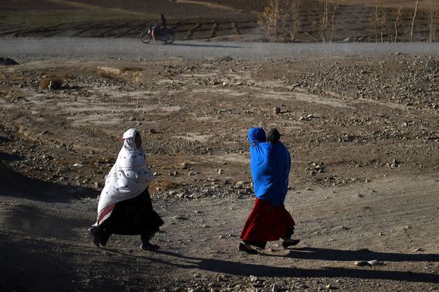 Hazara women walk along a road in Afghanistan's Bamiyan Province, Nov. 6, 2016. (Photo: WAKIL KOHSAR via Getty Images)